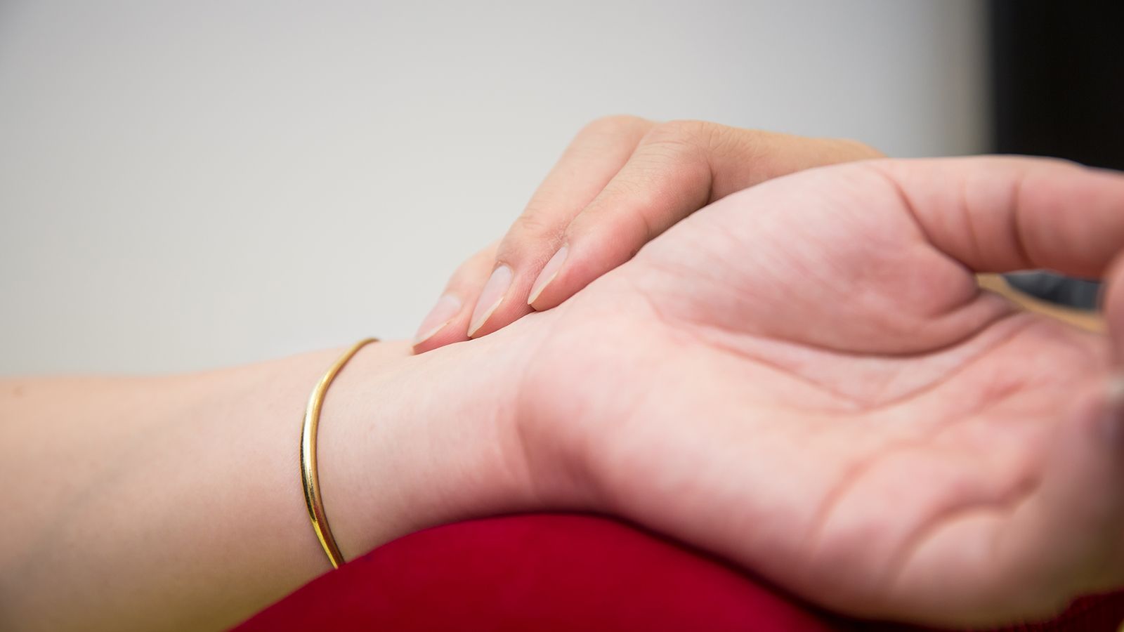 TCM practitioner checking a patient's pulse during a consultation